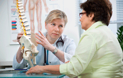 Chiropractor shows patient sacroiliac joint/spine.. Medical vs. Chiropractic Study