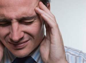 Man with migraine headache. Study shows chiropractic care can help.